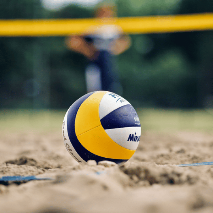 A volleyball sitting in some sand